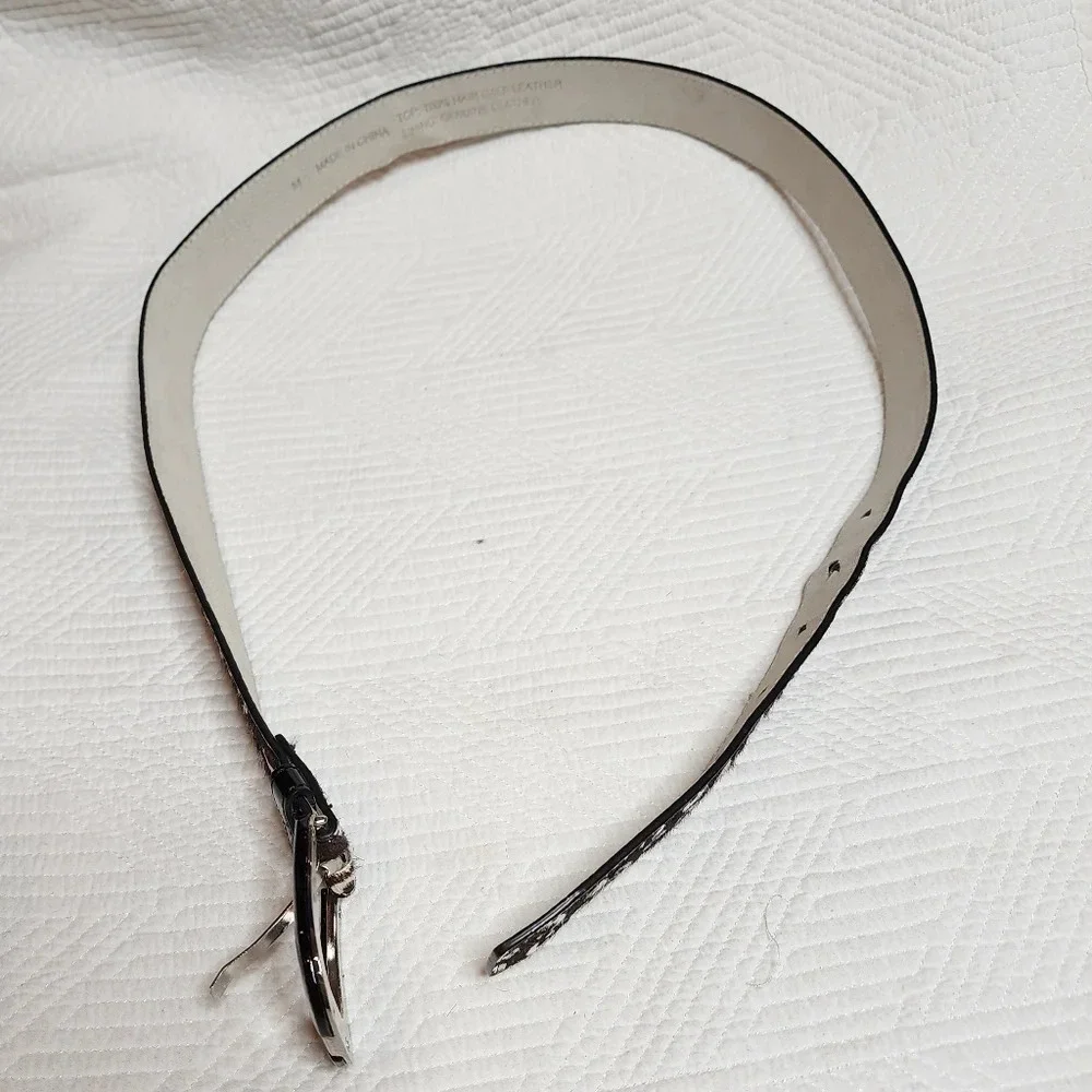 100% calf hair leather‎ dark brown, white spotted belt.